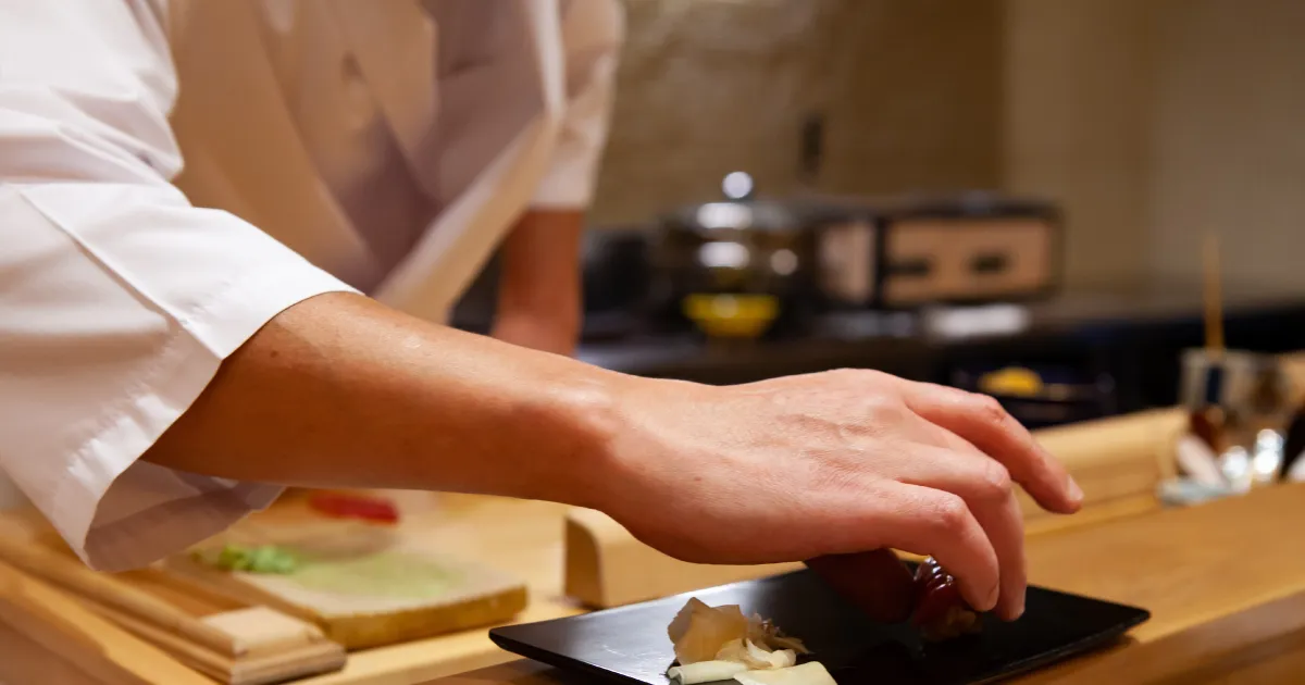 お客さんに寿司を提供する寿司職人